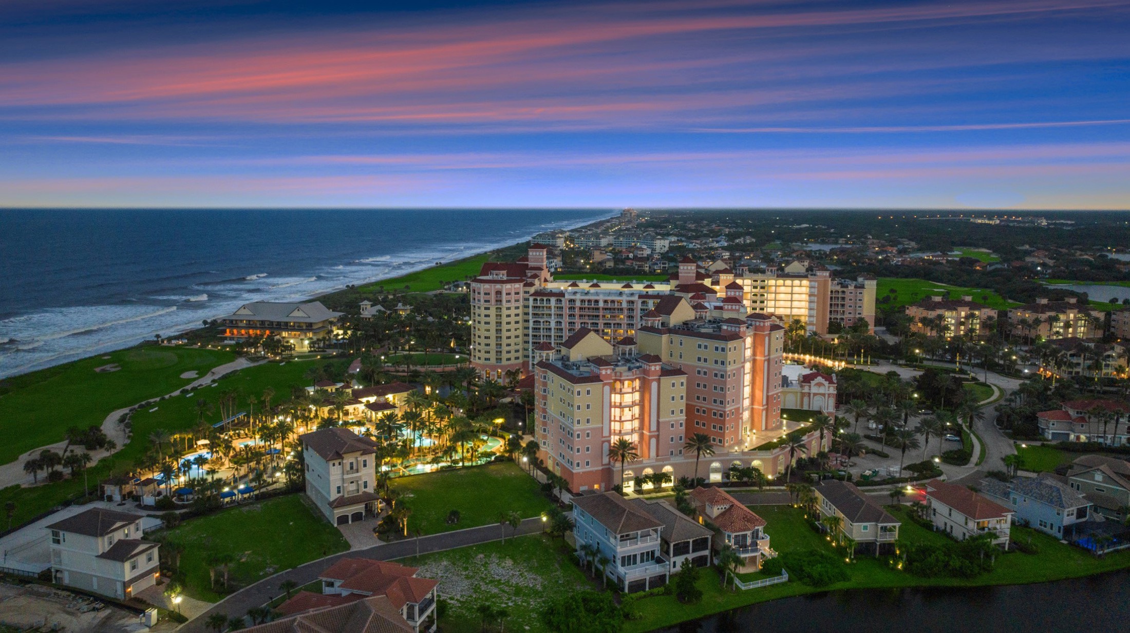 Aerial view of Hammock Beach Resort at dusk, with the Atlantic Ocean beyond